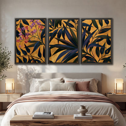 Dark pointed bamboo leaves across an ochre background with small pink floral accents 3 piece framed canvas wall art displayed in a bedroom