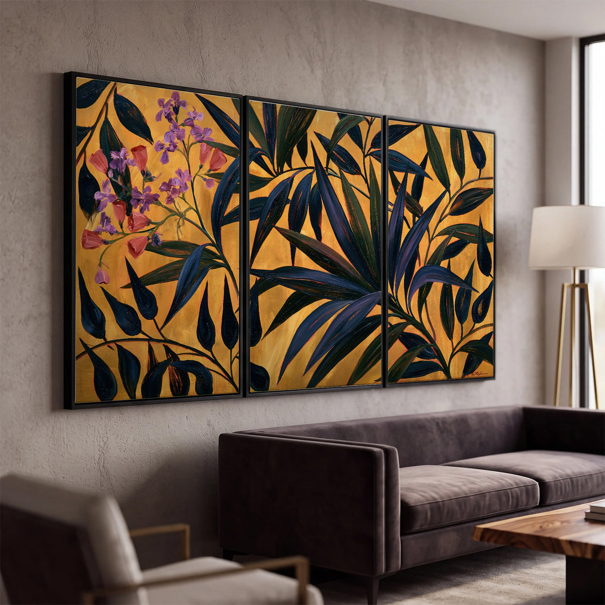 Dark pointed bamboo leaves across an ochre background with small pink floral accents 3 piece framed canvas wall art displayed in a modern living room