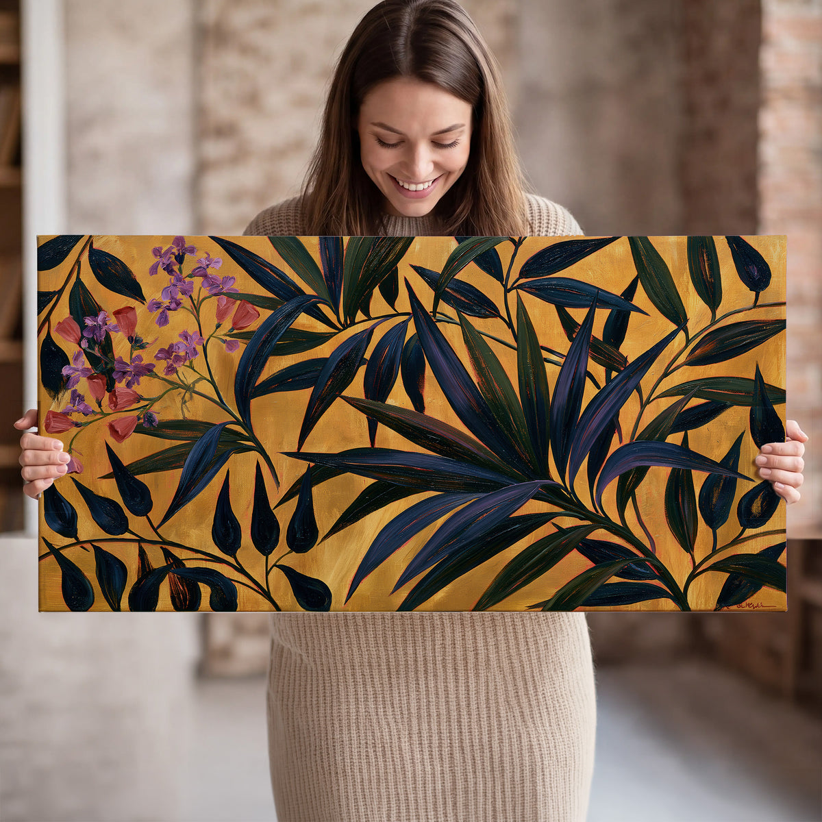 Dark pointed bamboo leaves across an ochre background with small pink floral accents single canvas wall art held in hands