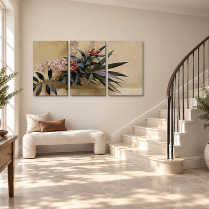 Long dark leaves and dusty pink flowers arranged against a soft beige background 3 piece canvas wall art styled in an interior
