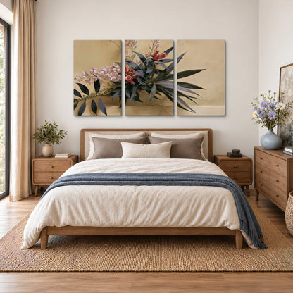 Long dark leaves and dusty pink flowers arranged against a soft beige background 3 piece canvas wall art styled in an interior