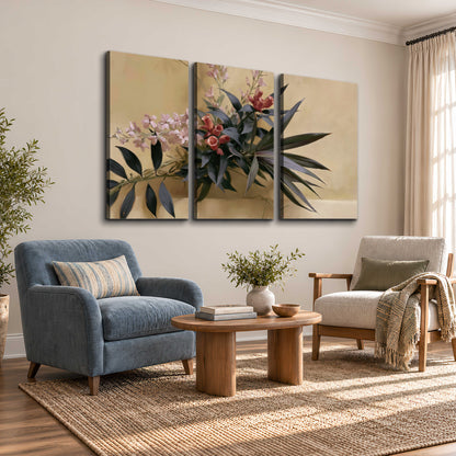 Long dark leaves and dusty pink flowers arranged against a soft beige background 3 piece canvas wall art styled in an interior