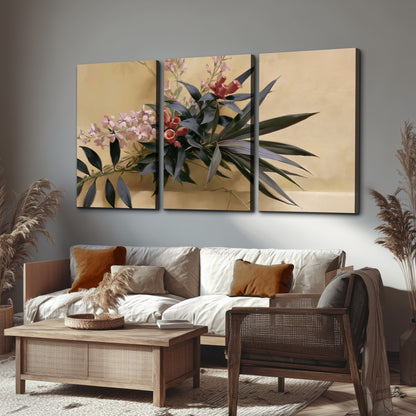 Long dark leaves and dusty pink flowers arranged against a soft beige background 3 piece canvas wall art displayed in a rustic living room