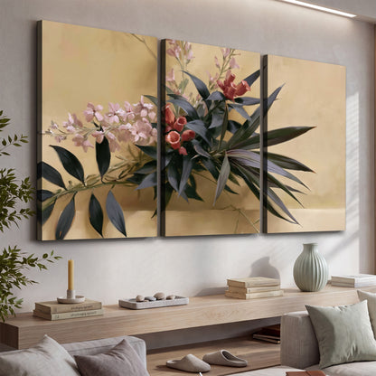 Long dark leaves and dusty pink flowers arranged against a soft beige background 3 piece canvas wall art displayed in a console