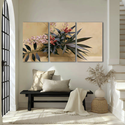Long dark leaves and dusty pink flowers arranged against a soft beige background 3 piece canvas wall art displayed in a entryway