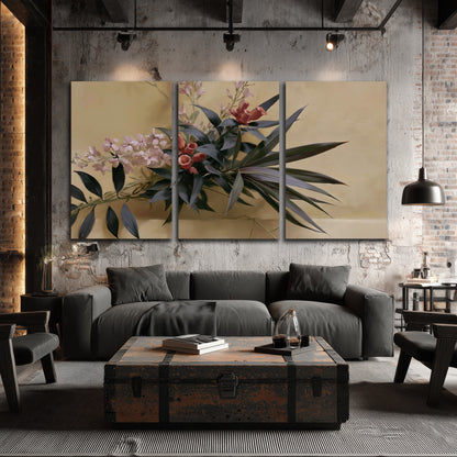 Long dark leaves and dusty pink flowers arranged against a soft beige background 3 piece canvas wall art displayed in a industrial room