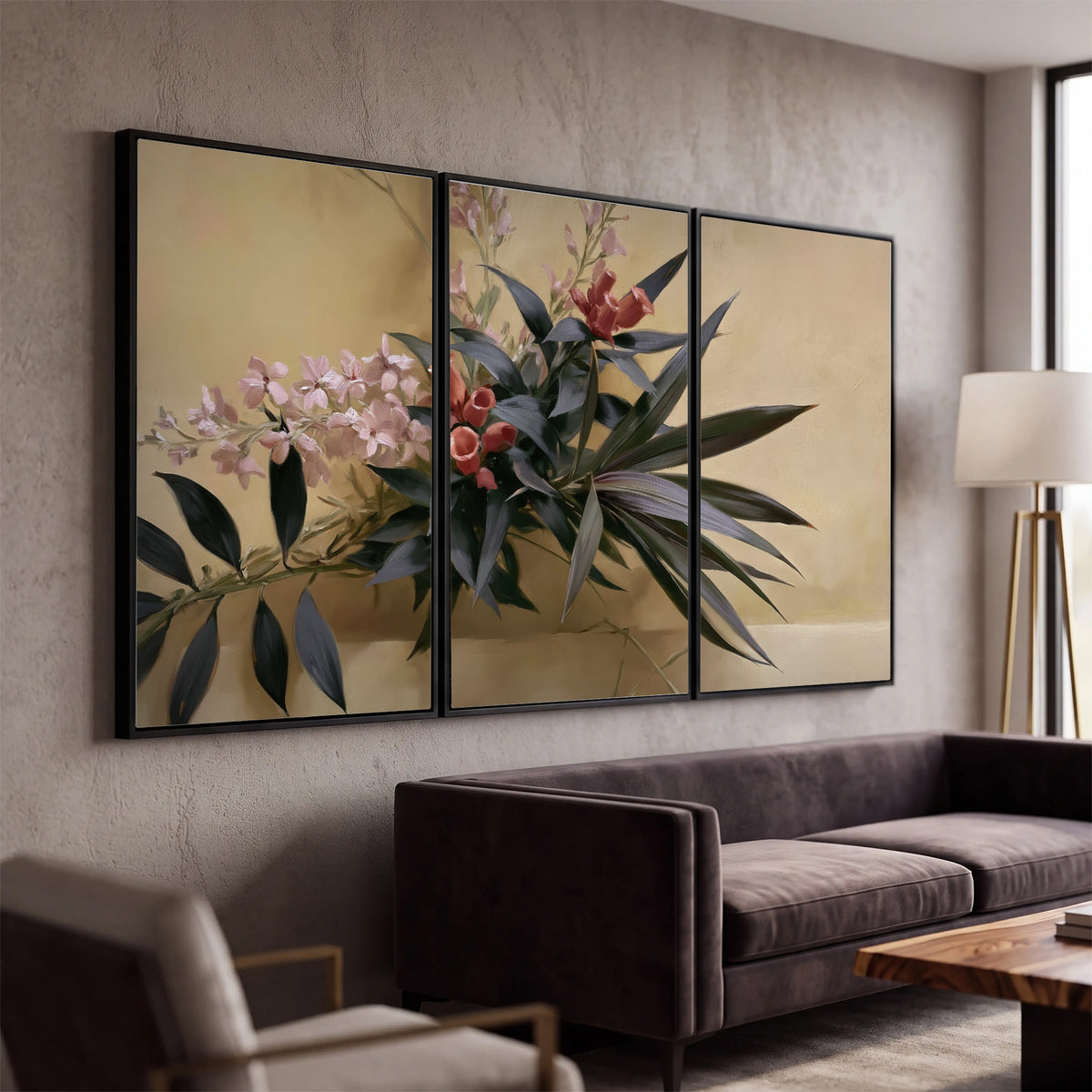 Long dark leaves and dusty pink flowers arranged against a soft beige background 3 piece framed canvas wall art displayed in a modern living room