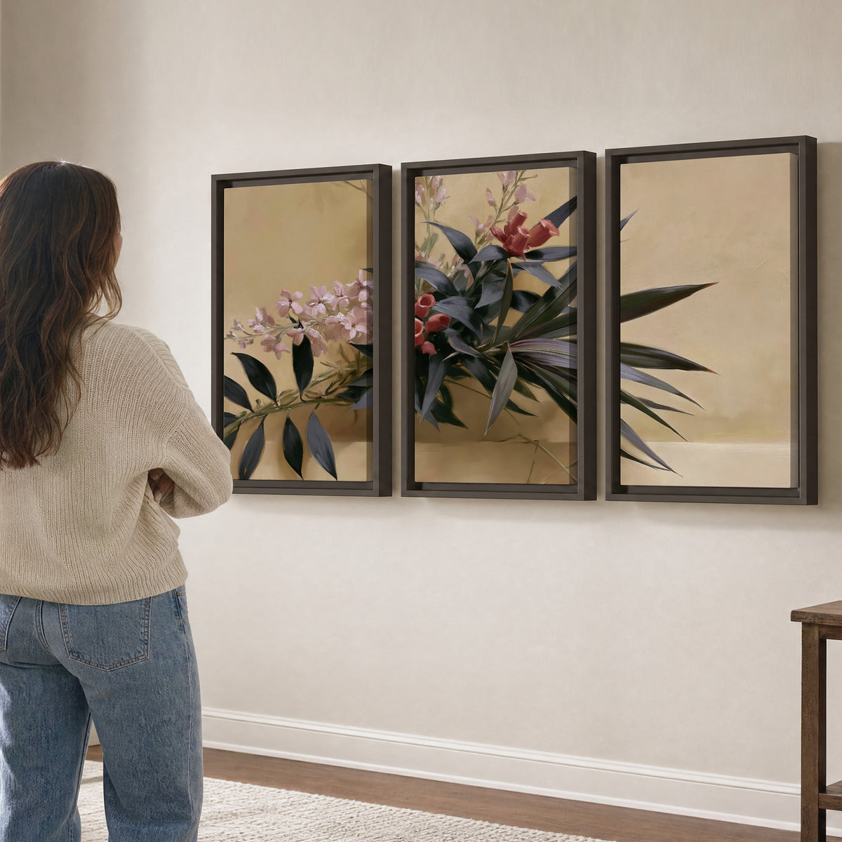 Long dark leaves and dusty pink flowers arranged against a soft beige background 3 piece framed canvas wall art three panel arrangement on a wall