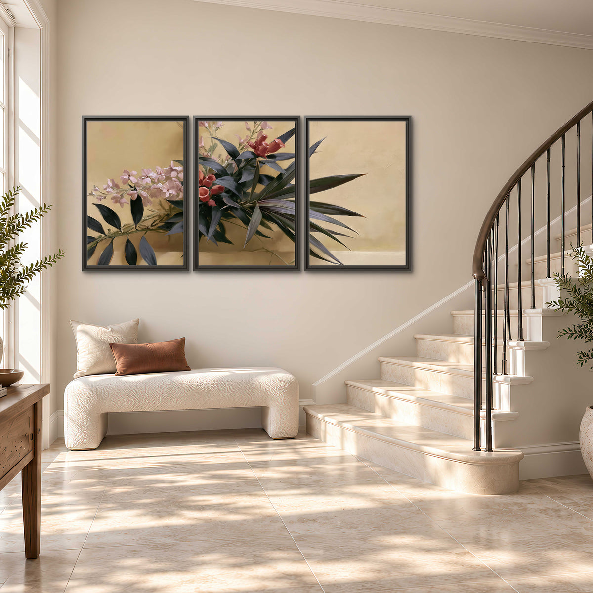 Long dark leaves and dusty pink flowers arranged against a soft beige background 3 piece framed canvas wall art styled in an interior