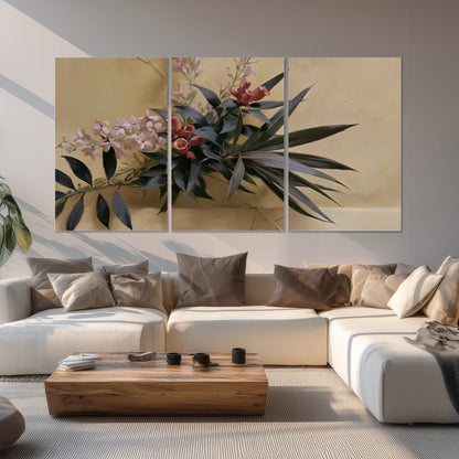Long dark leaves and dusty pink flowers arranged against a soft beige background set of 3 poster prints displayed in a living room