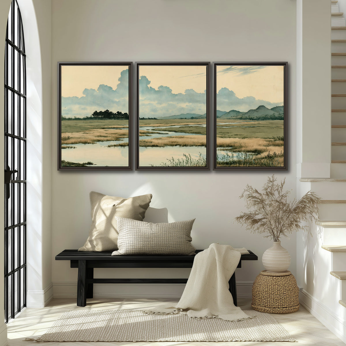 A calm marshland with reflective pools and distant blue-green hills under a clouded sky 3 piece framed canvas wall art displayed in a entryway