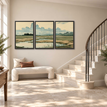 A calm marshland with reflective pools and distant blue-green hills under a clouded sky 3 piece framed canvas wall art styled in an interior