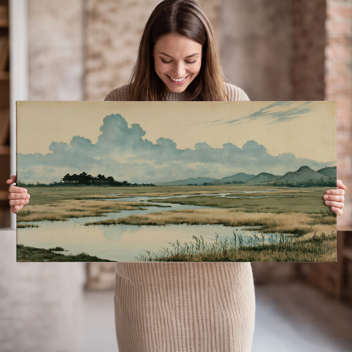 A calm marshland with reflective pools and distant blue-green hills under a clouded sky single canvas wall art held in hands
