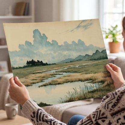 A calm marshland with reflective pools and distant blue-green hills under a clouded sky single poster print held in hands