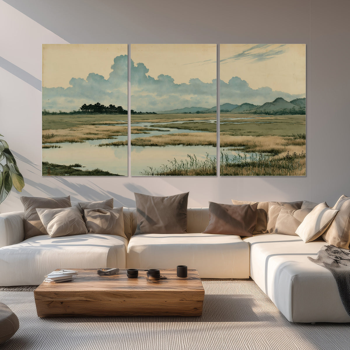 A calm marshland with reflective pools and distant blue-green hills under a clouded sky set of 3 poster prints displayed in a living room
