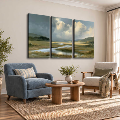 A winding stream through an open meadow beneath large sunlit clouds 3 piece canvas wall art styled in an interior