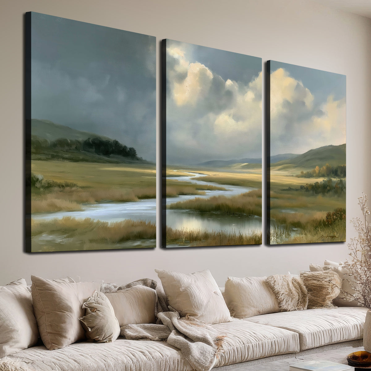 A winding stream through an open meadow beneath large sunlit clouds 3 piece canvas wall art room and product view