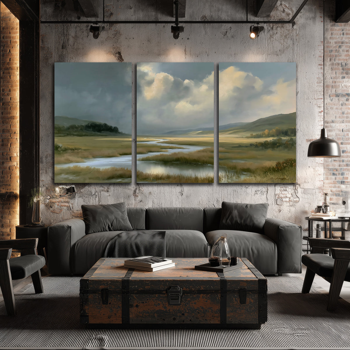 A winding stream through an open meadow beneath large sunlit clouds 3 piece canvas wall art displayed in a industrial room