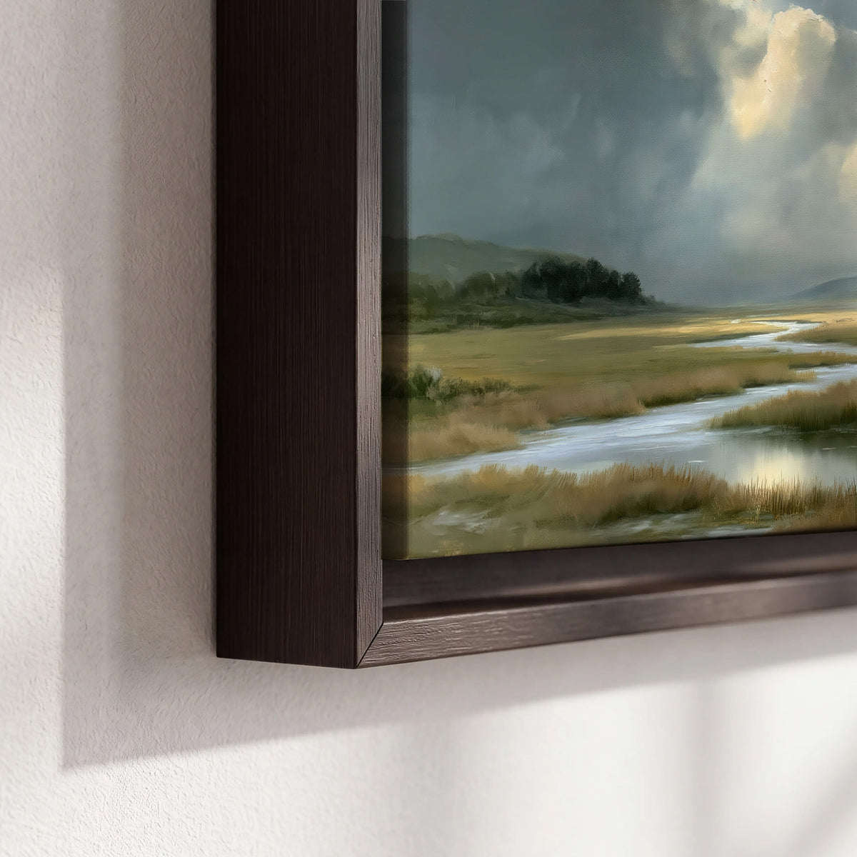 A winding stream through an open meadow beneath large sunlit clouds 3 piece framed canvas wall art material and edge close up