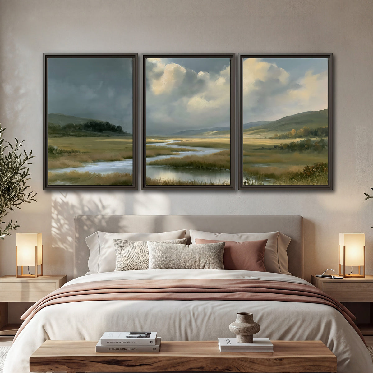 A winding stream through an open meadow beneath large sunlit clouds 3 piece framed canvas wall art displayed in a bedroom