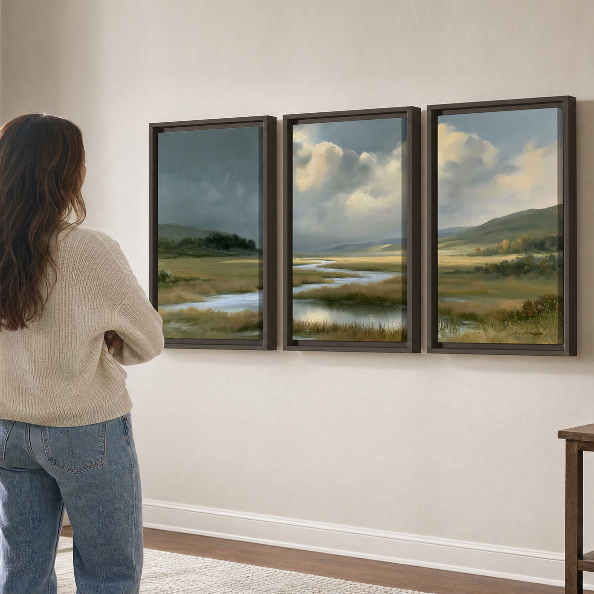A winding stream through an open meadow beneath large sunlit clouds 3 piece framed canvas wall art three panel arrangement on a wall
