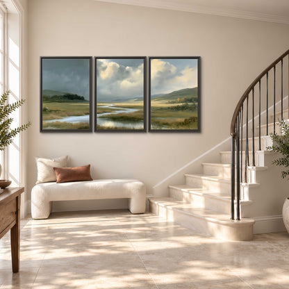 A winding stream through an open meadow beneath large sunlit clouds 3 piece framed canvas wall art styled in an interior