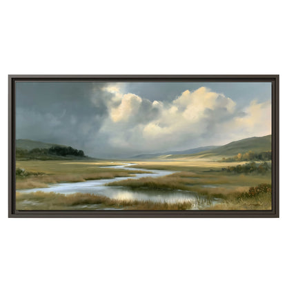 A winding stream through an open meadow beneath large sunlit clouds single framed canvas wall art viewed straight on
