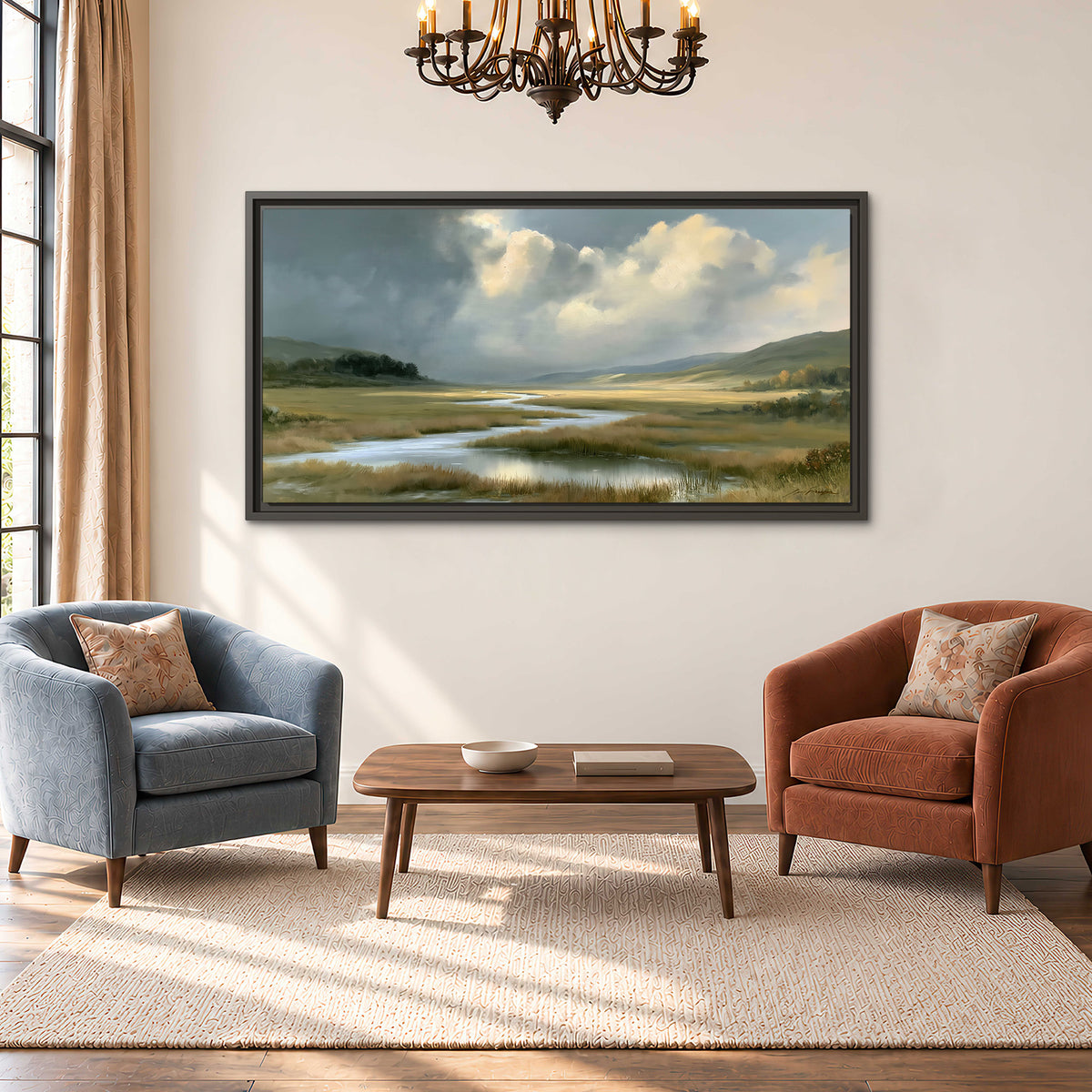 A winding stream through an open meadow beneath large sunlit clouds single framed canvas wall art styled in an interior