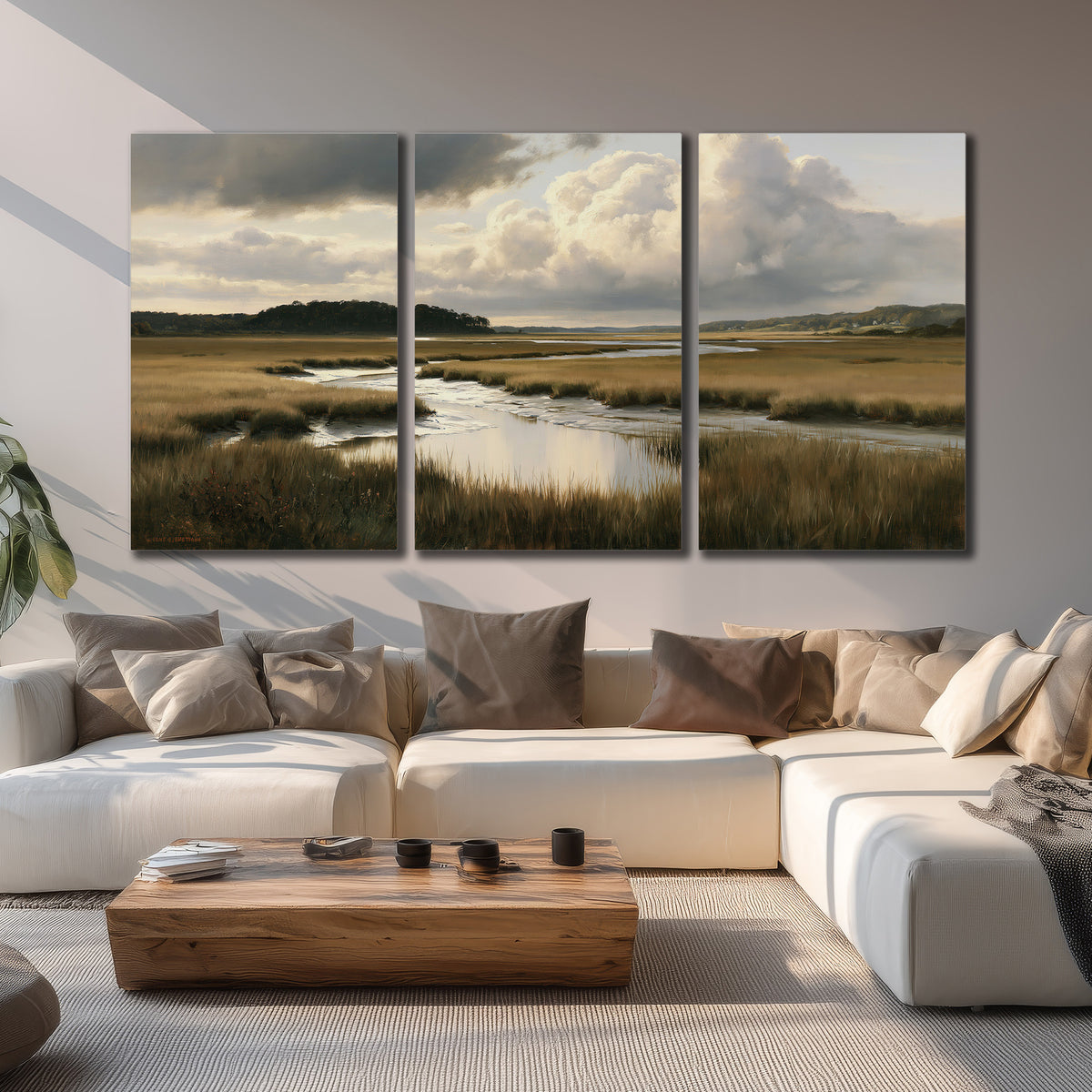 Pools of still water reflecting a dramatic cloud-filled sky across a golden marsh 3 piece canvas wall art displayed in a living room