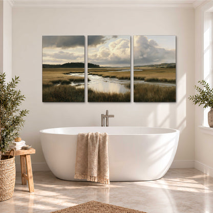 Pools of still water reflecting a dramatic cloud-filled sky across a golden marsh 3 piece canvas wall art styled in an interior