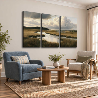 Pools of still water reflecting a dramatic cloud-filled sky across a golden marsh 3 piece canvas wall art styled in an interior