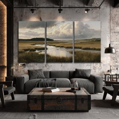 Pools of still water reflecting a dramatic cloud-filled sky across a golden marsh 3 piece canvas wall art displayed in a industrial room
