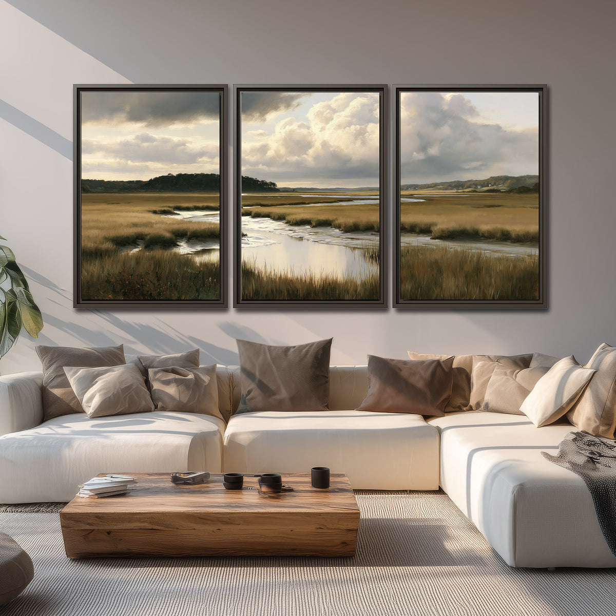 Pools of still water reflecting a dramatic cloud-filled sky across a golden marsh 3 piece framed canvas wall art displayed in a living room