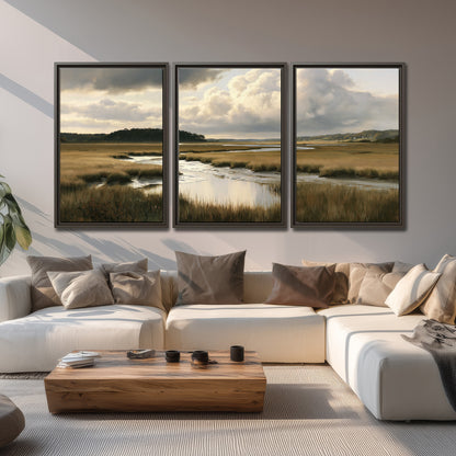 Pools of still water reflecting a dramatic cloud-filled sky across a golden marsh 3 piece framed canvas wall art displayed in a living room
