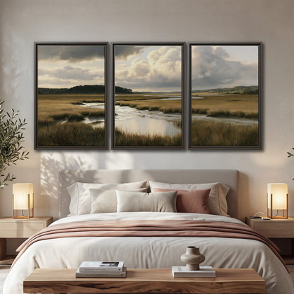 Pools of still water reflecting a dramatic cloud-filled sky across a golden marsh 3 piece framed canvas wall art displayed in a bedroom