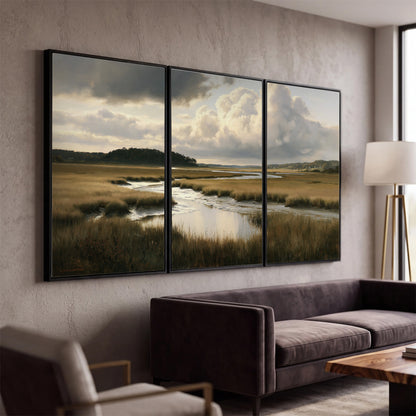 Pools of still water reflecting a dramatic cloud-filled sky across a golden marsh 3 piece framed canvas wall art displayed in a modern living room