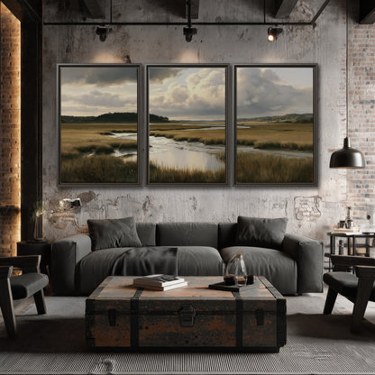 Pools of still water reflecting a dramatic cloud-filled sky across a golden marsh 3 piece framed canvas wall art displayed in a industrial room