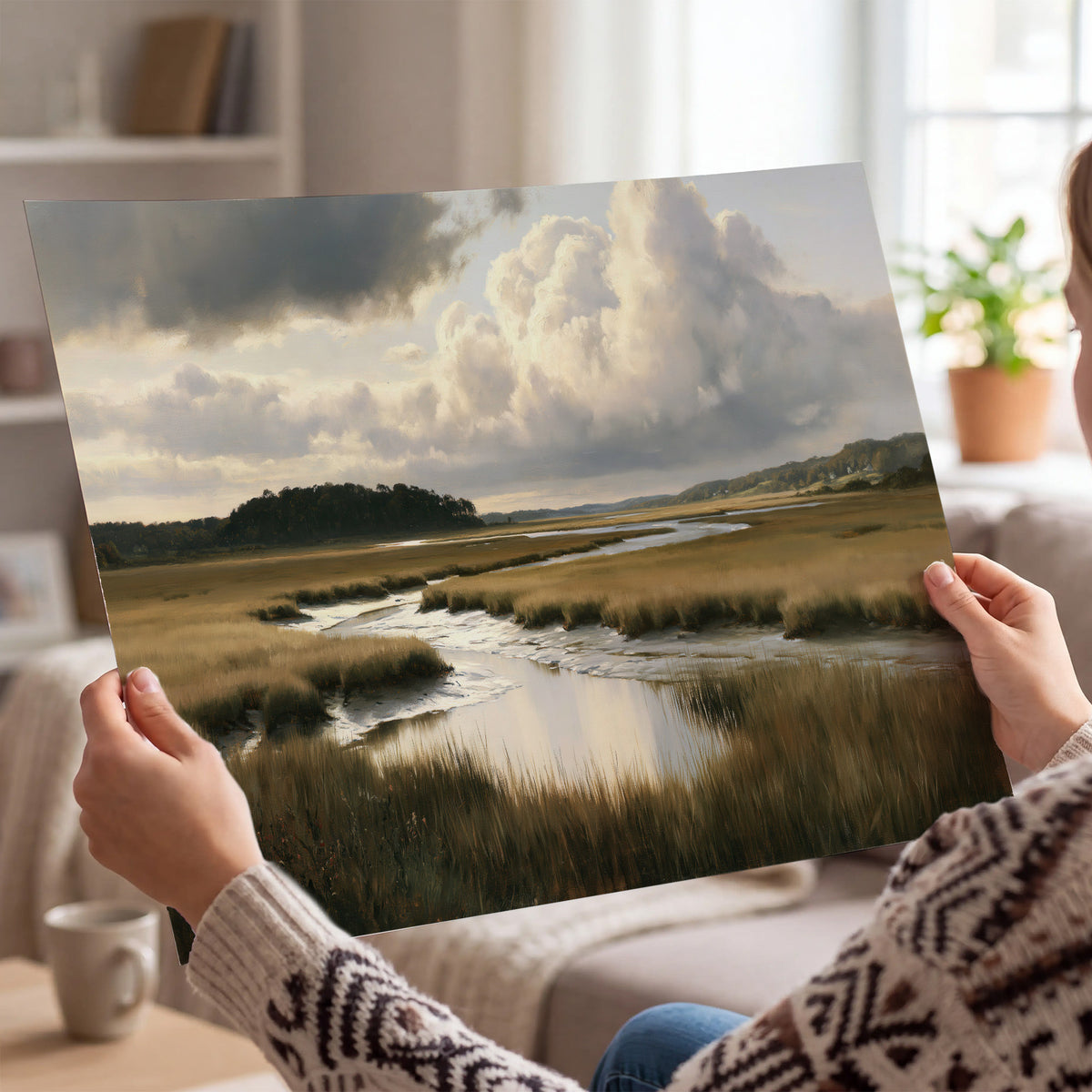 Pools of still water reflecting a dramatic cloud-filled sky across a golden marsh single poster print held in hands
