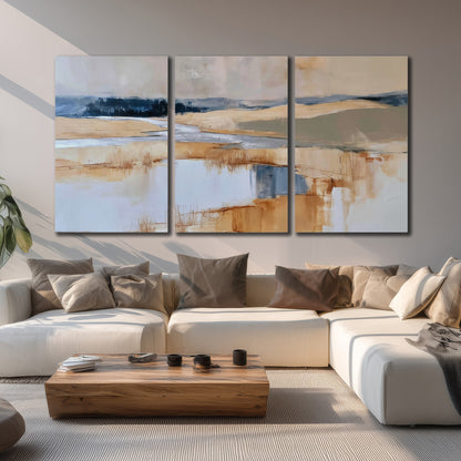 Soft horizontal bands of blue, ochre and ivory suggesting a reflected marsh landscape 3 piece canvas wall art displayed in a living room
