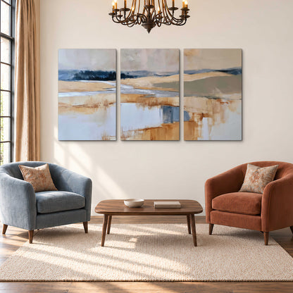 Soft horizontal bands of blue, ochre and ivory suggesting a reflected marsh landscape 3 piece canvas wall art styled in an interior