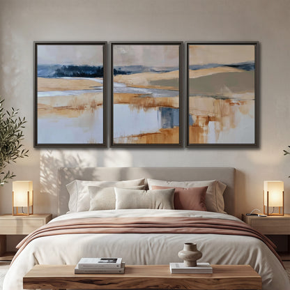 Soft horizontal bands of blue, ochre and ivory suggesting a reflected marsh landscape 3 piece framed canvas wall art displayed in a bedroom