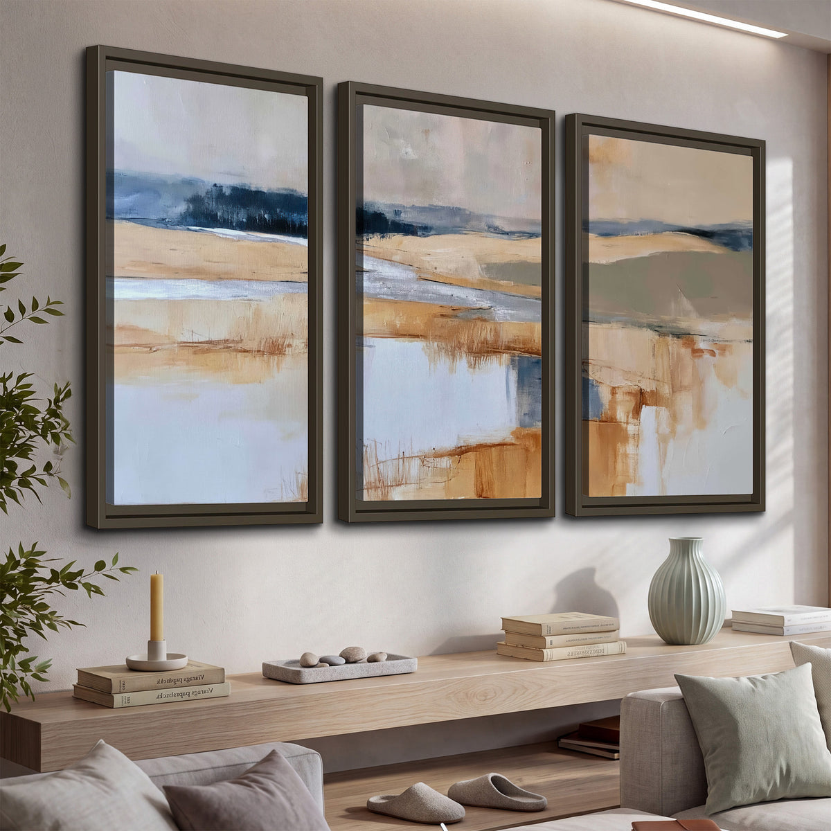 Soft horizontal bands of blue, ochre and ivory suggesting a reflected marsh landscape 3 piece framed canvas wall art displayed in a console