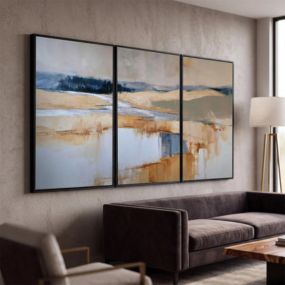 Soft horizontal bands of blue, ochre and ivory suggesting a reflected marsh landscape 3 piece framed canvas wall art displayed in a modern living room