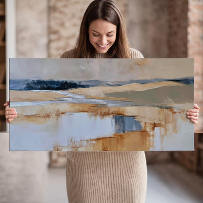 Soft horizontal bands of blue, ochre and ivory suggesting a reflected marsh landscape single canvas wall art held in hands