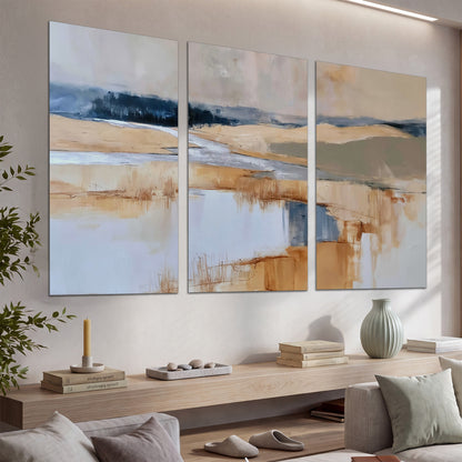 Soft horizontal bands of blue, ochre and ivory suggesting a reflected marsh landscape set of 3 poster prints displayed in a console