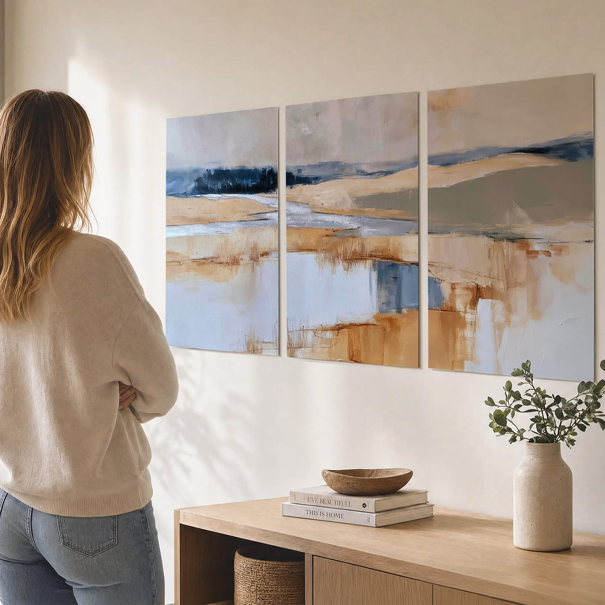Soft horizontal bands of blue, ochre and ivory suggesting a reflected marsh landscape set of 3 poster prints three panel arrangement on a wall