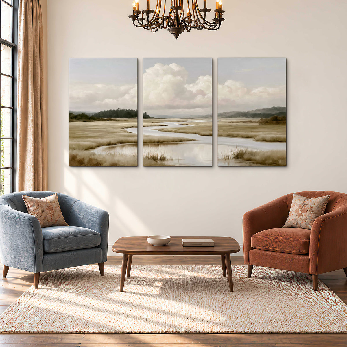 A pale winding waterway crossing quiet wetlands beneath billowing white clouds 3 piece canvas wall art styled in an interior