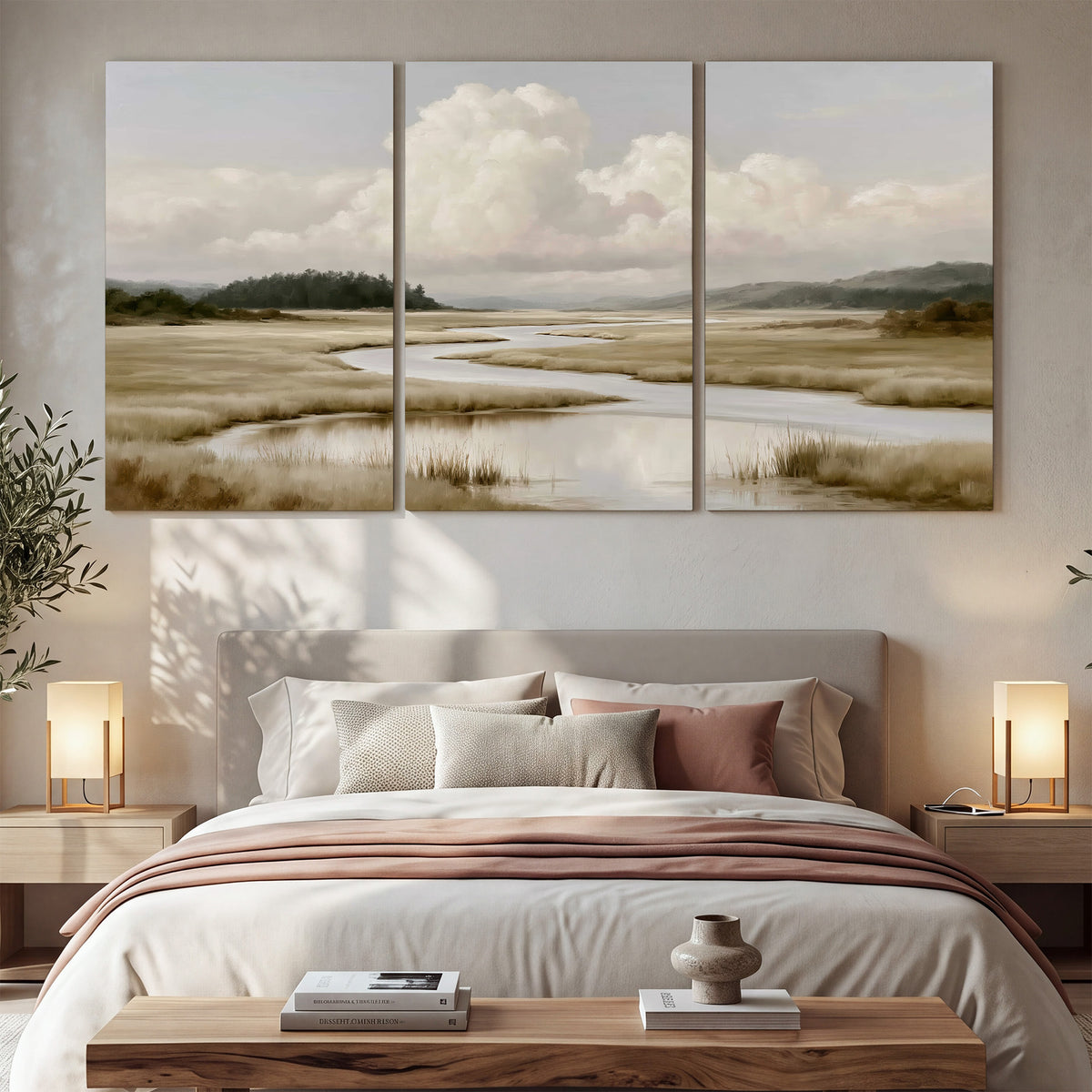 A pale winding waterway crossing quiet wetlands beneath billowing white clouds 3 piece canvas wall art displayed in a bedroom