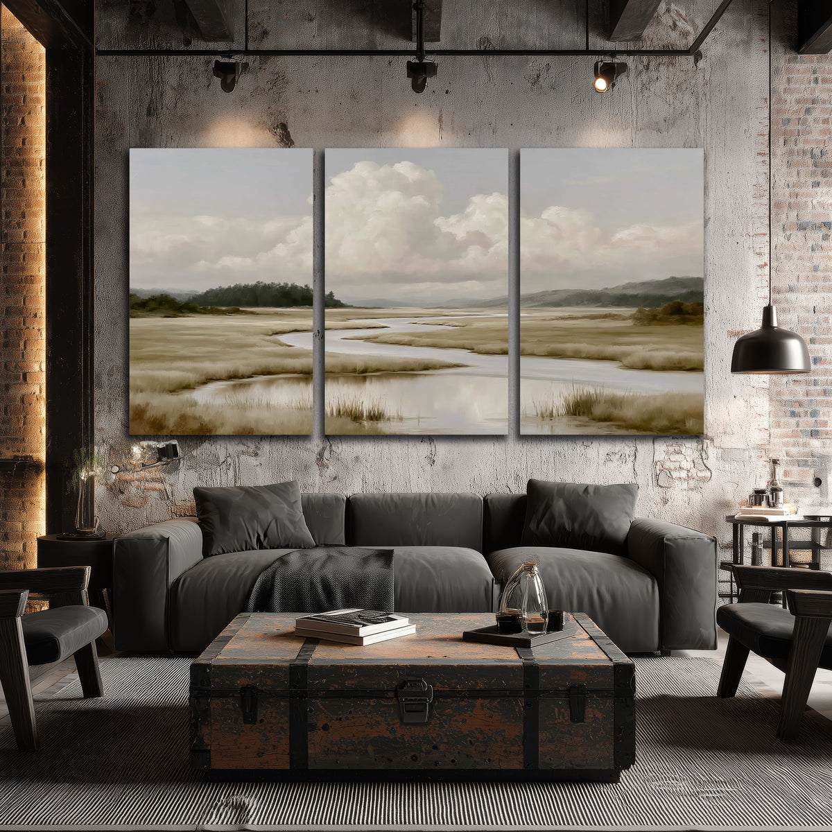 A pale winding waterway crossing quiet wetlands beneath billowing white clouds 3 piece canvas wall art displayed in a industrial room