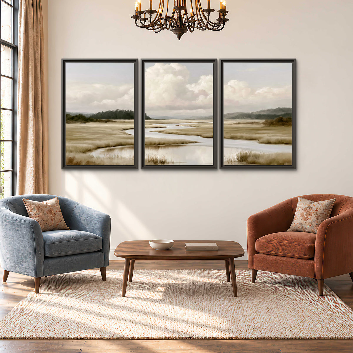 A pale winding waterway crossing quiet wetlands beneath billowing white clouds 3 piece framed canvas wall art styled in an interior